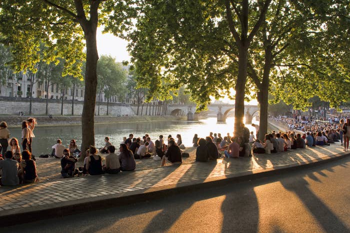 Picnickers sitting on the bank of the Seine