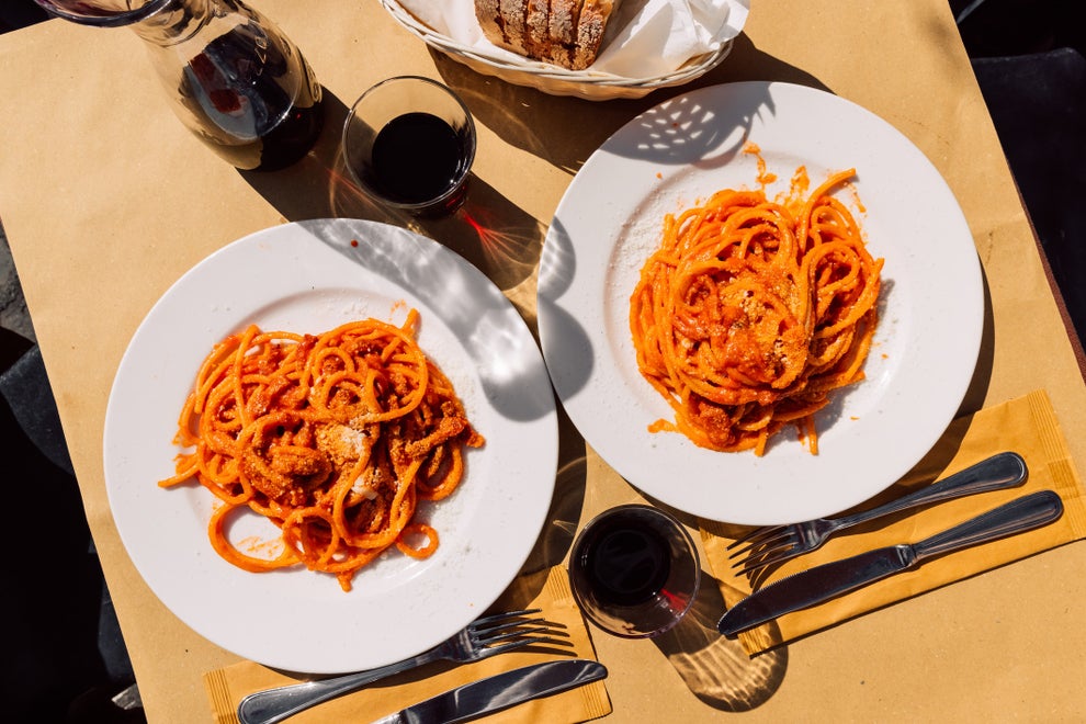 Pasta amatriciana and wine on a plate