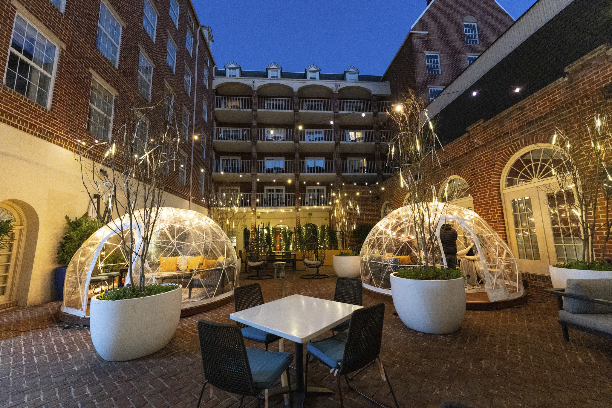 Temperature controlled outdoor igloos in a hotel courtyard