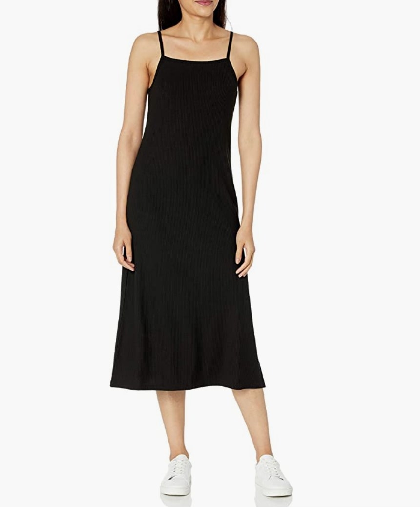 A model wearing a black spaghetti strap midi dress