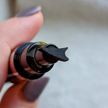 Reviewer's eyeliner pen with wing-shaped stamp