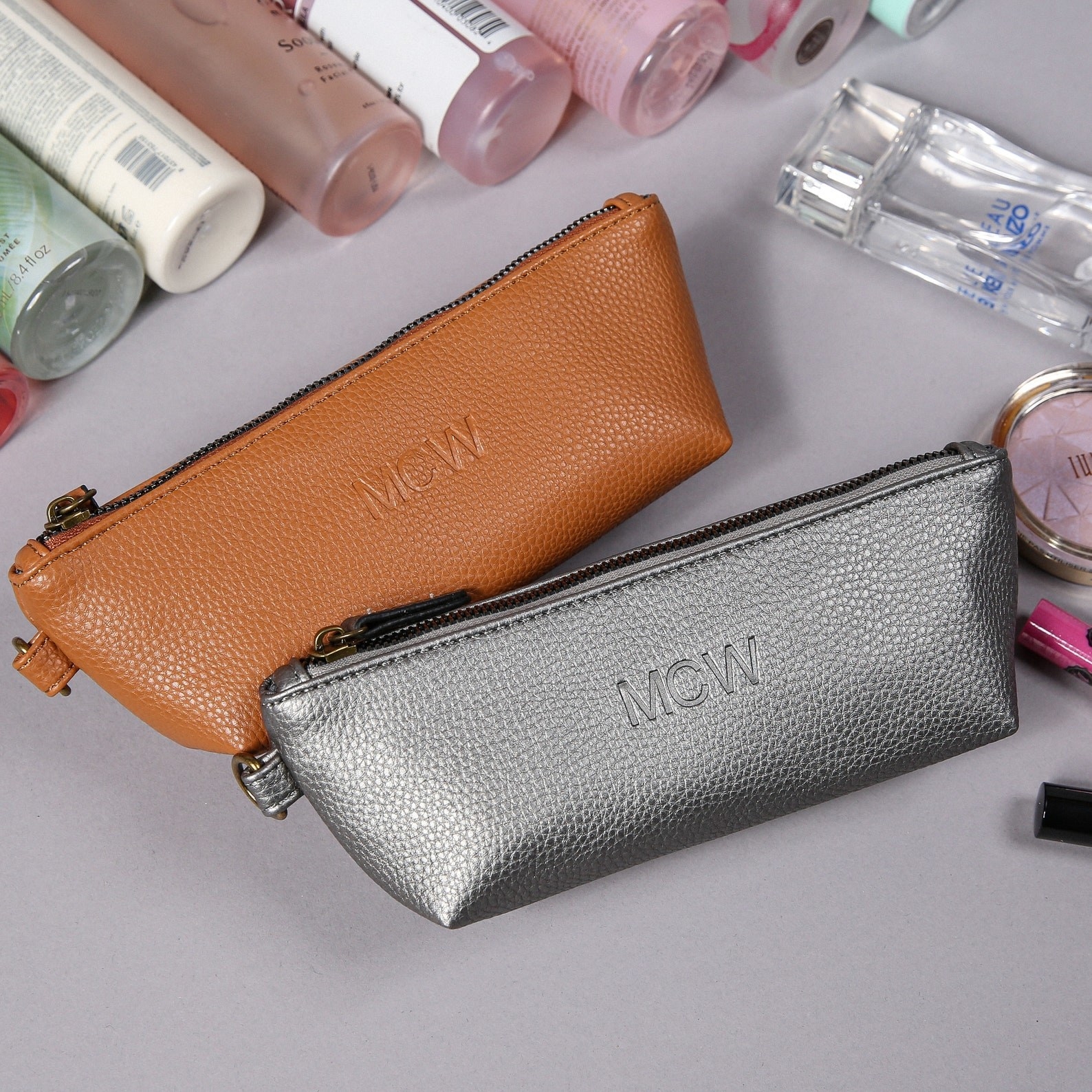 brown leather and silver leather zippered pencil cases with &quot;MCW&quot; embossed on them