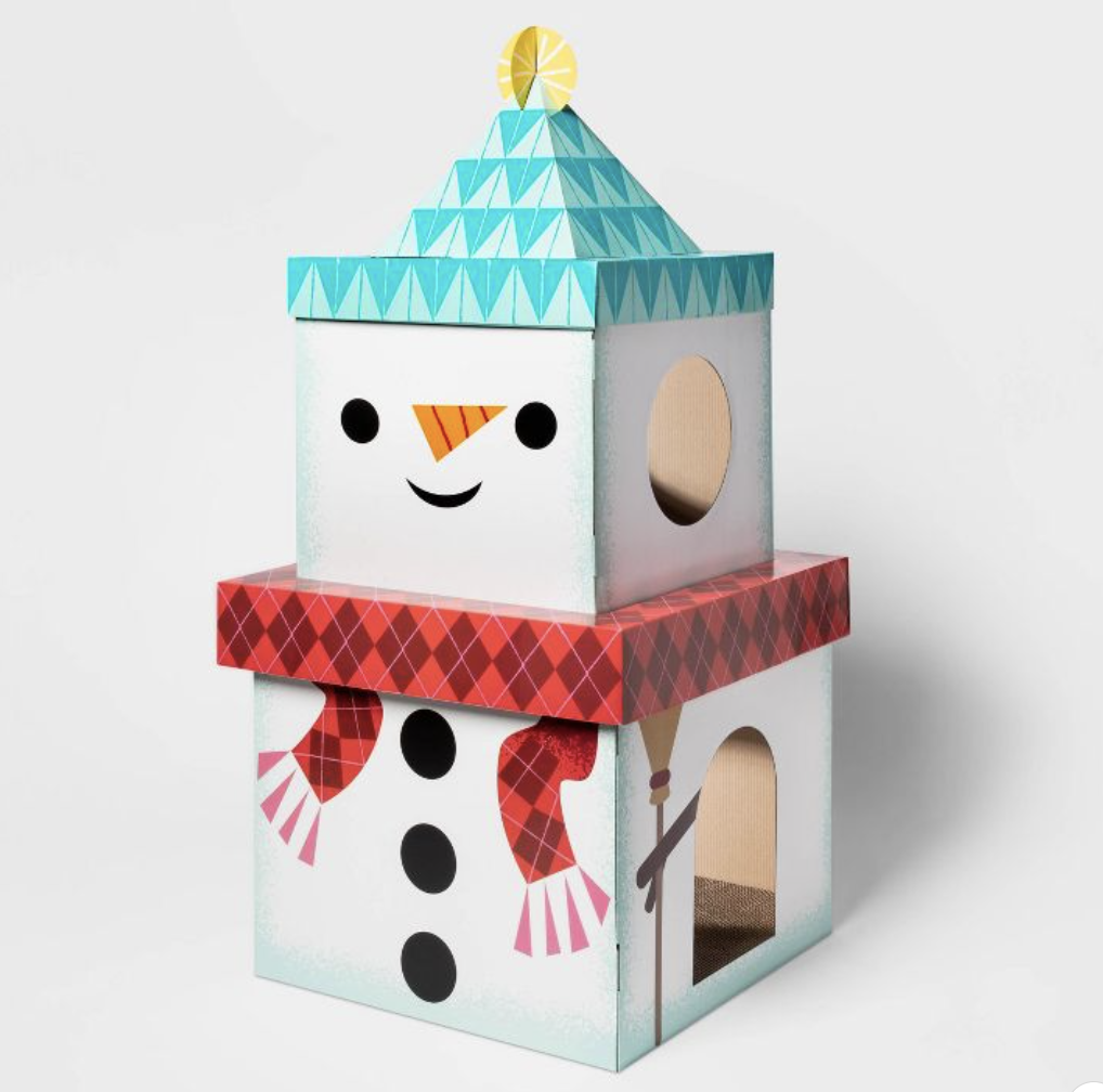 A cardboard cat scratcher with two levels, decorated to resemble a snowman