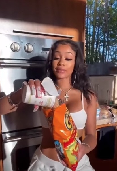 saweetie pouring ramen into a hot cheetos bag