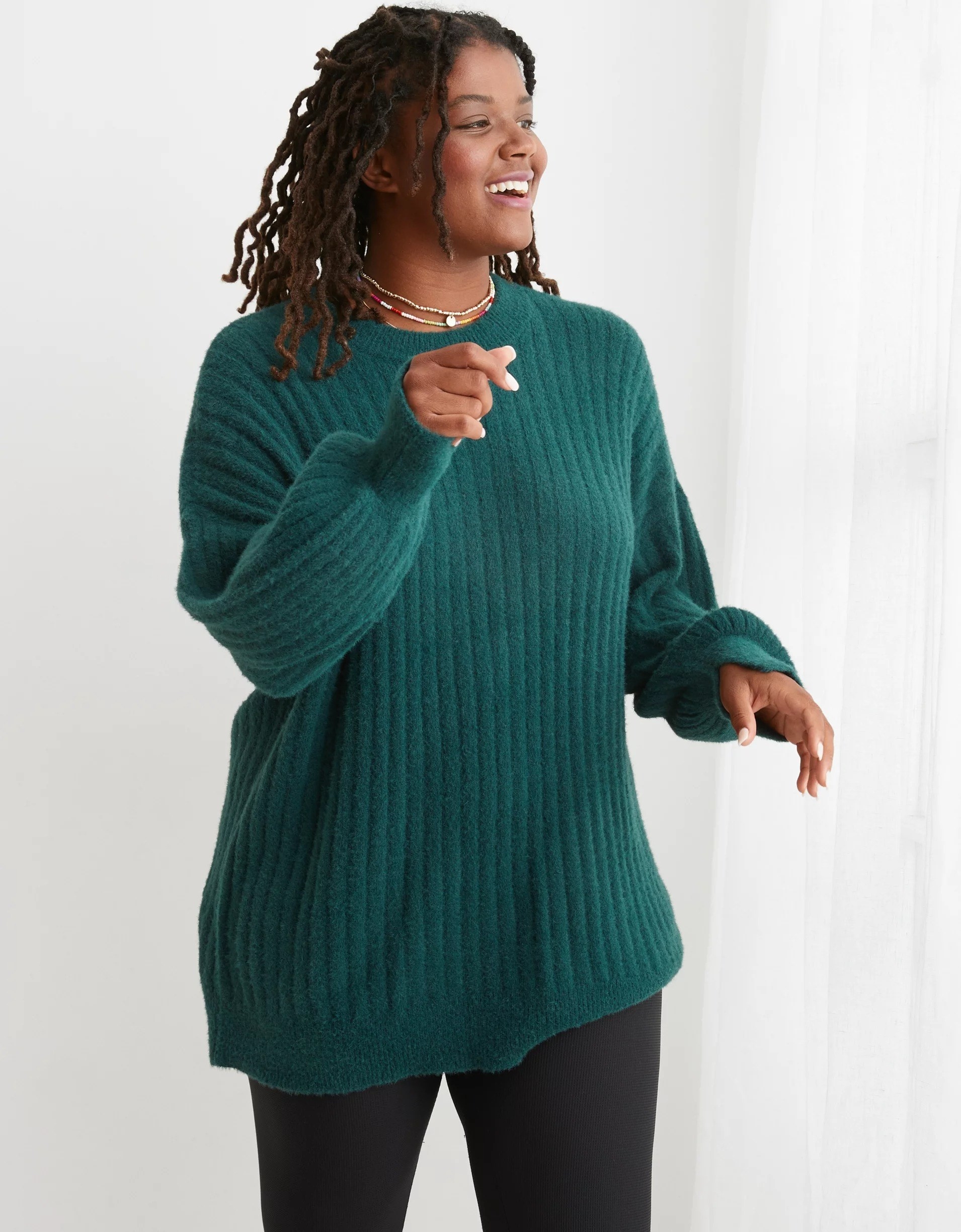 a model wearing the dark green sweater