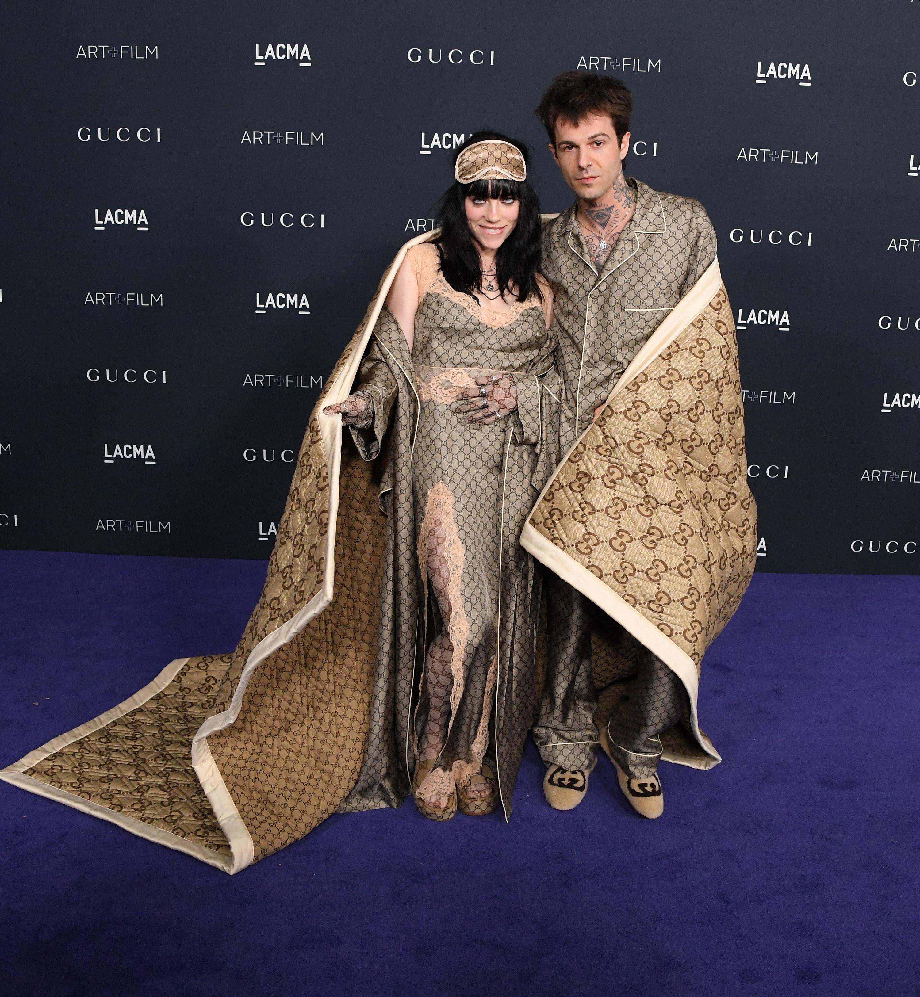 the couple wrapping themselves in the blanket on the red carpet