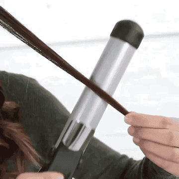 A model curling their hair automatically