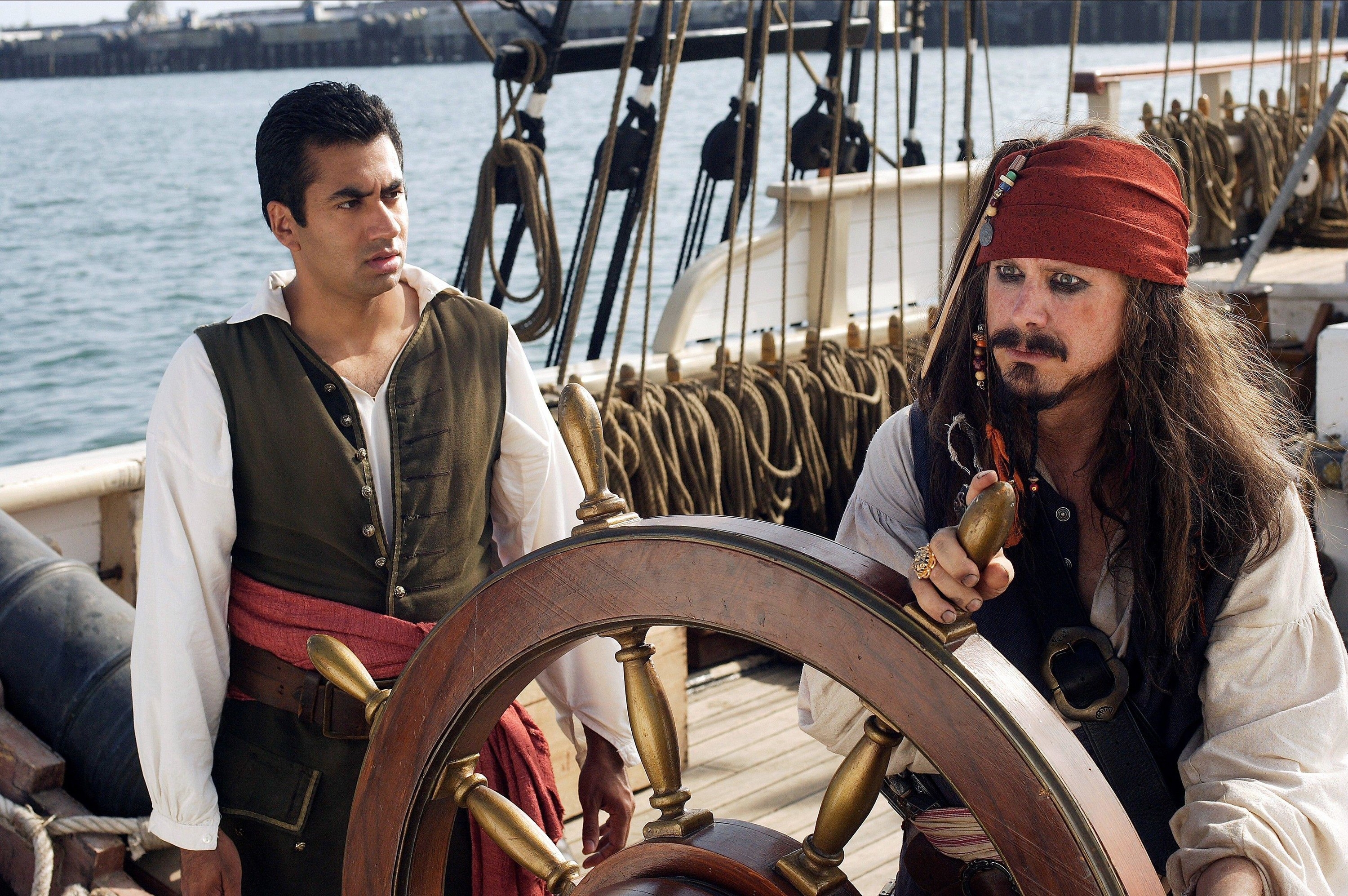Two pirates speak on a galleon