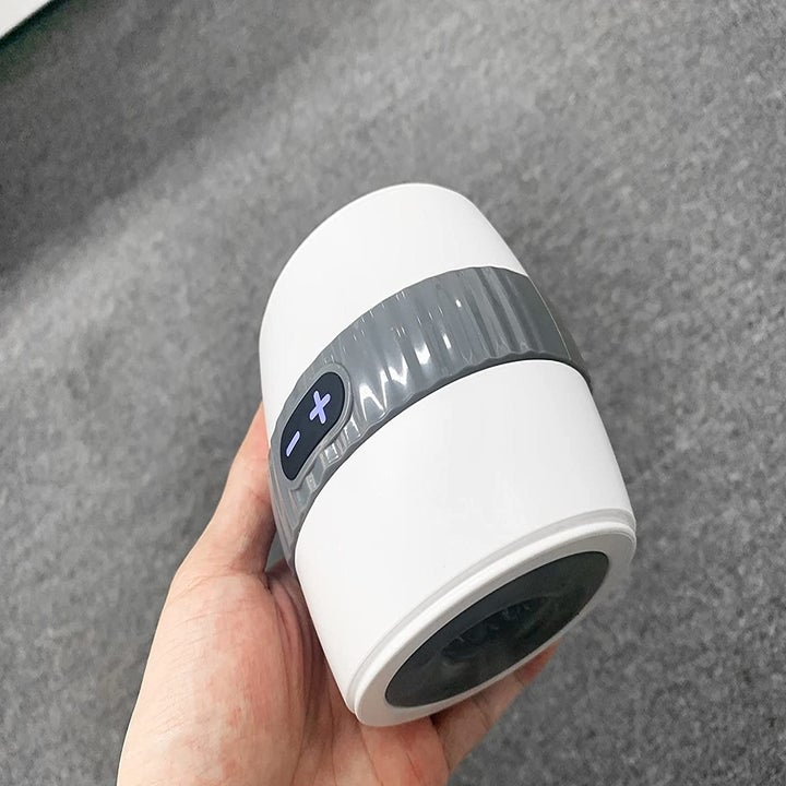 Reviewer holding white open-ended stroker