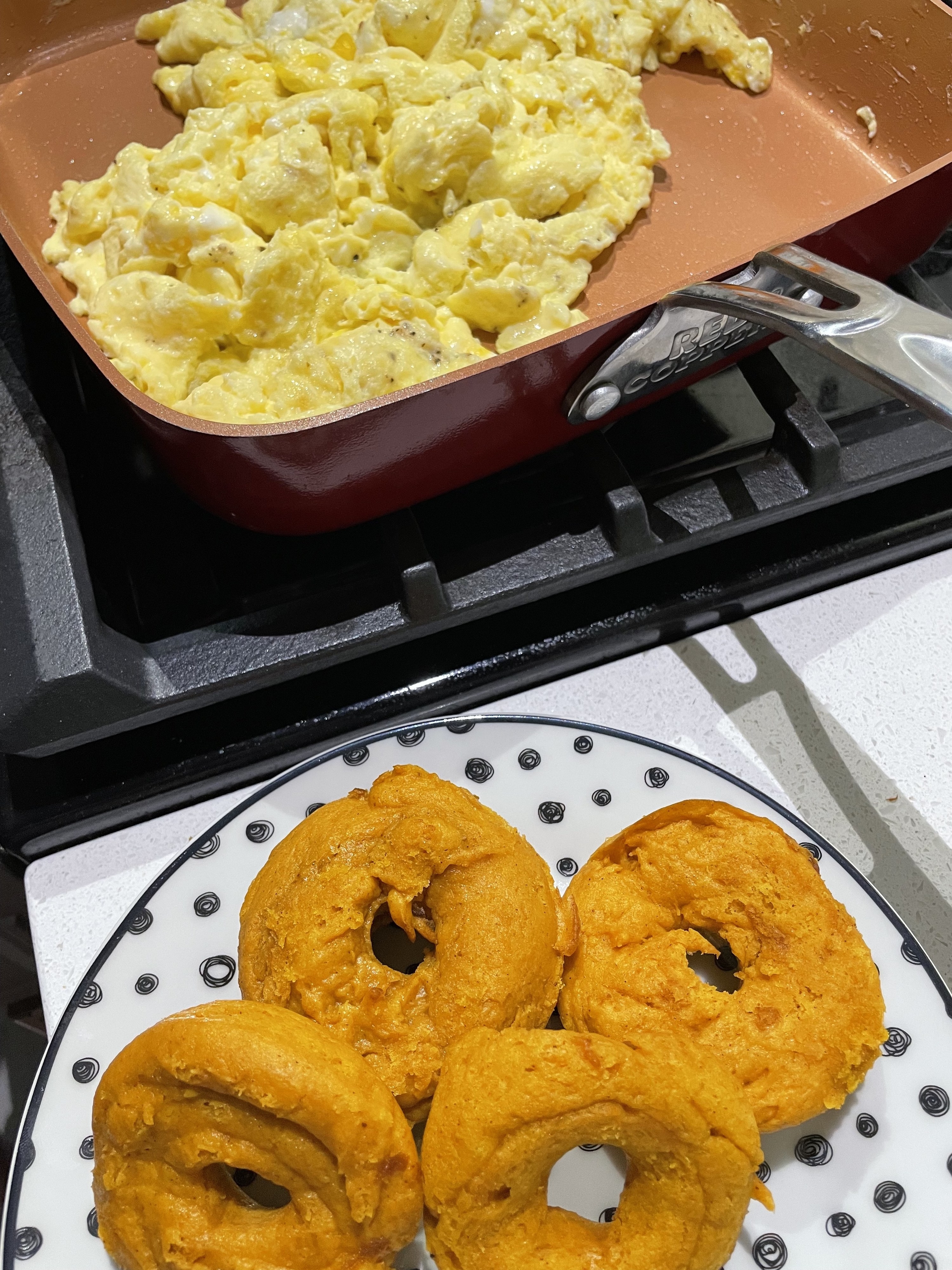 eggs in a pan and pumpkin donuts
