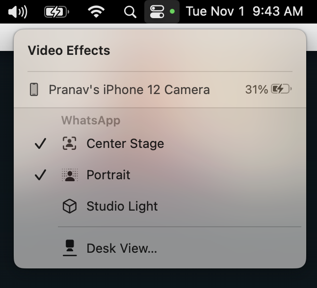 A dropdown menu on a computer screen shows that Pranav&#x27;s iPhone 12 Camera is attached with the WhatsApp options of Center Stage, Portrait, Studio Light, and Desk View