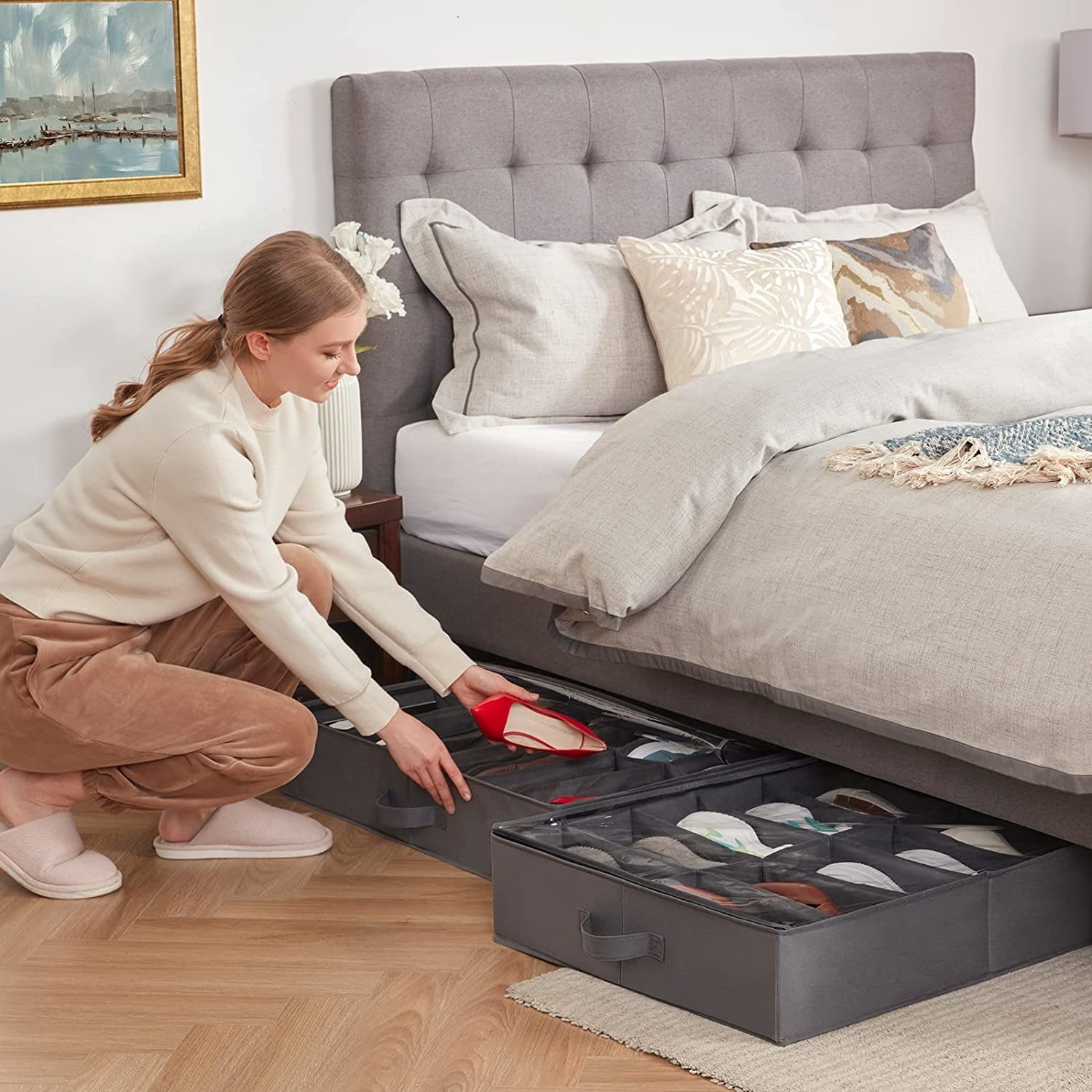 person sliding shoe box under the bed
