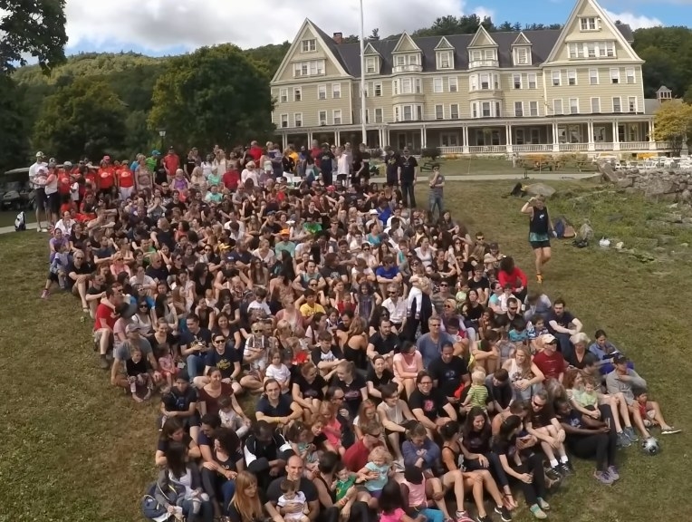 A group shot of members sitting together in on a lawn