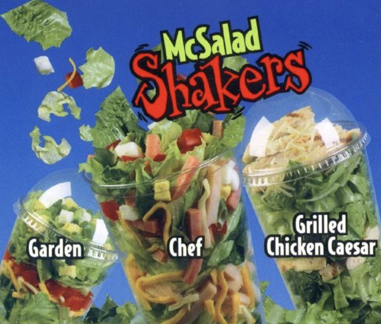 Cups of garden, chef, and grilled chicken Caesar salads