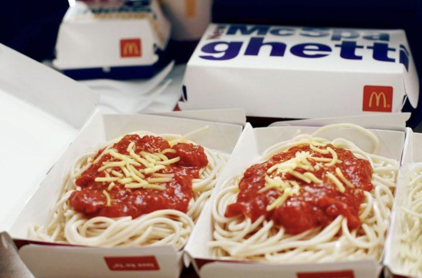 Spaghetti, red sauce, and cheese in a takeout box