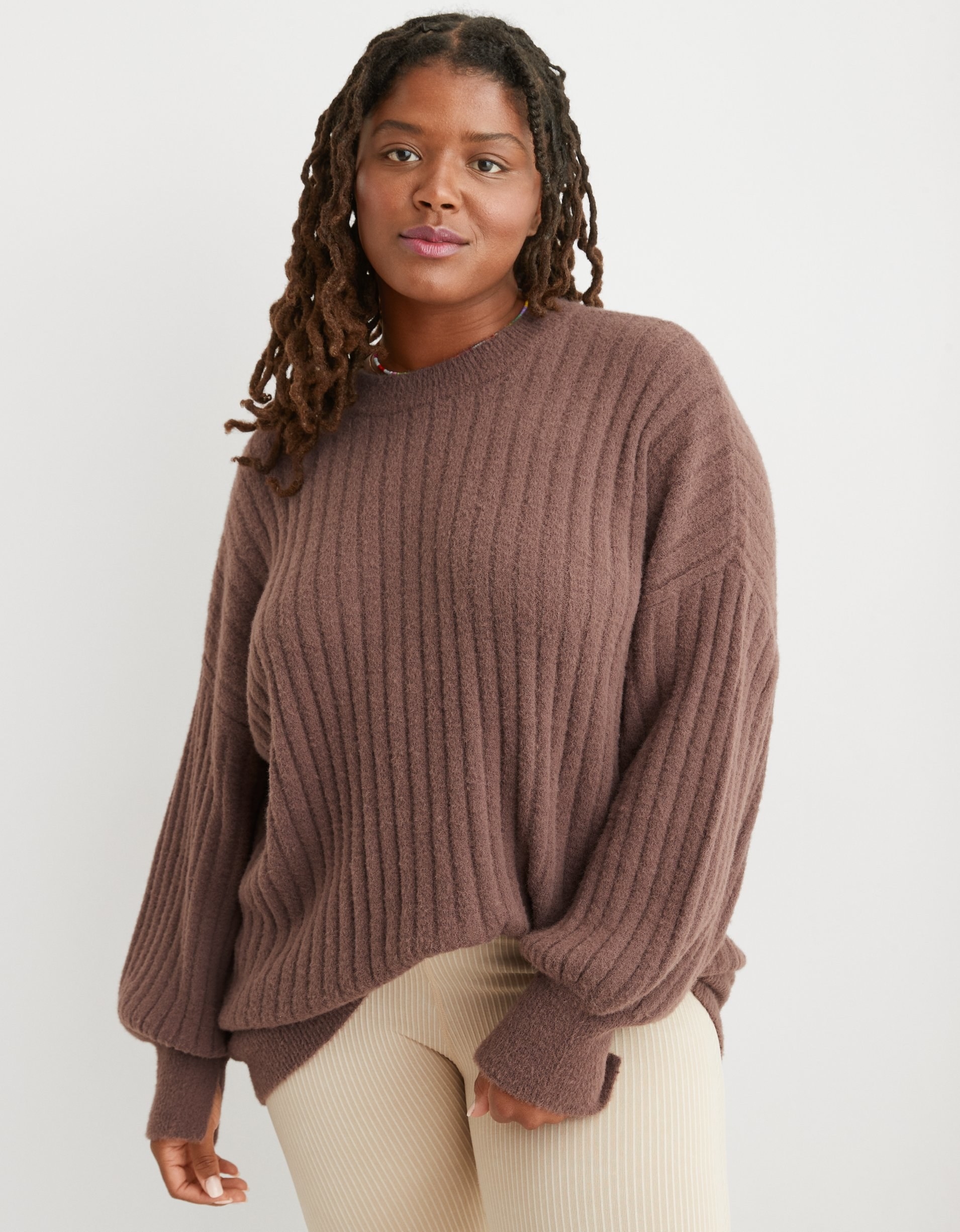 model in brown ribbed sweater with balloon sleeves