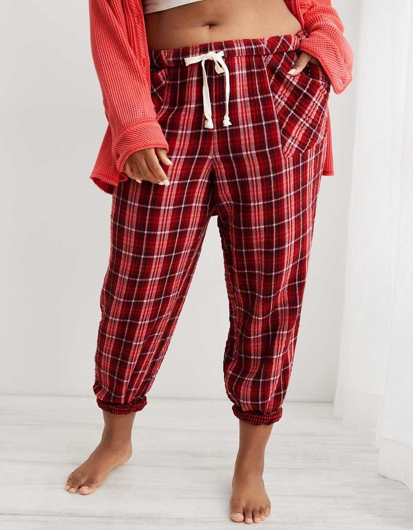model in red plaid jogger pj pants with a drawstring