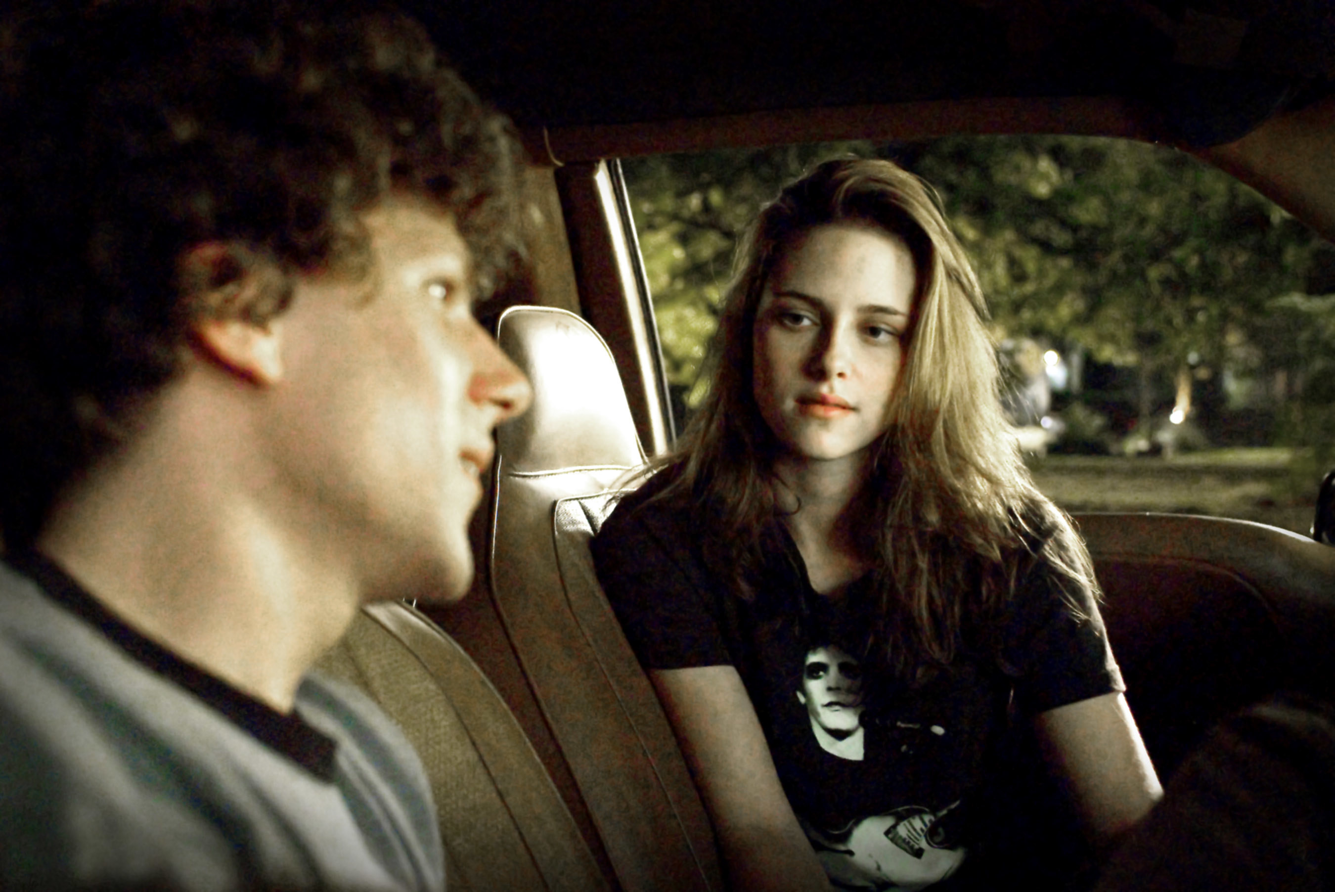 Jesse Eisenberg and Kristen Stewart sit in a car together
