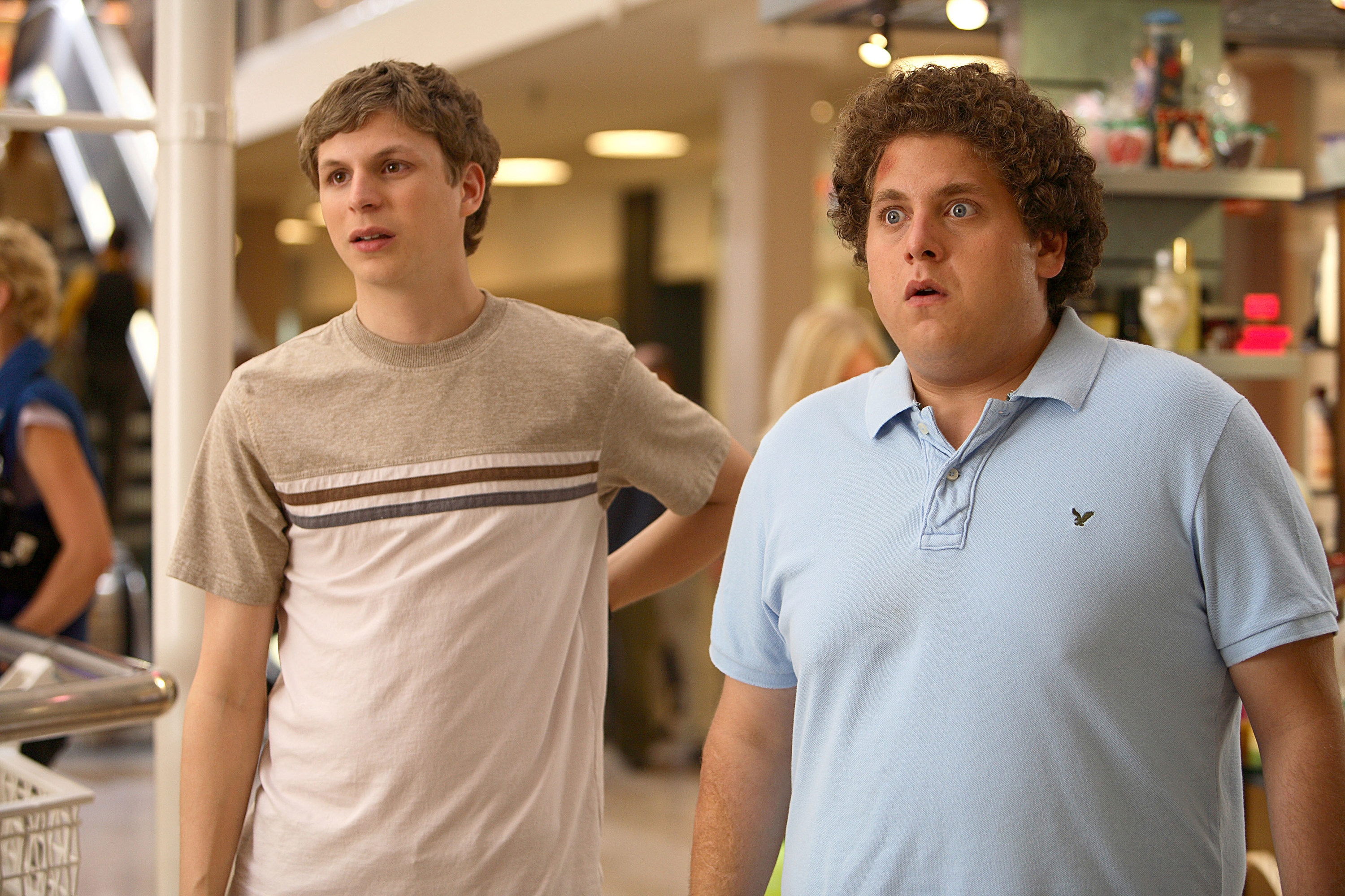 Michael Cera and Jonah Hill stand in a mall