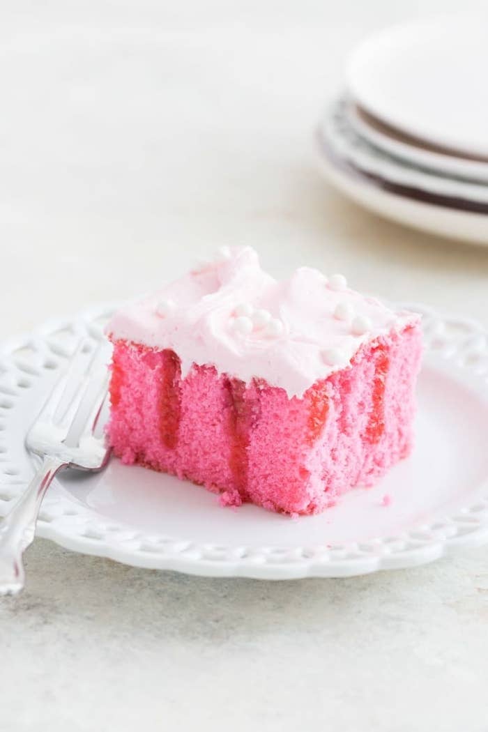 pink poke cake on a plate
