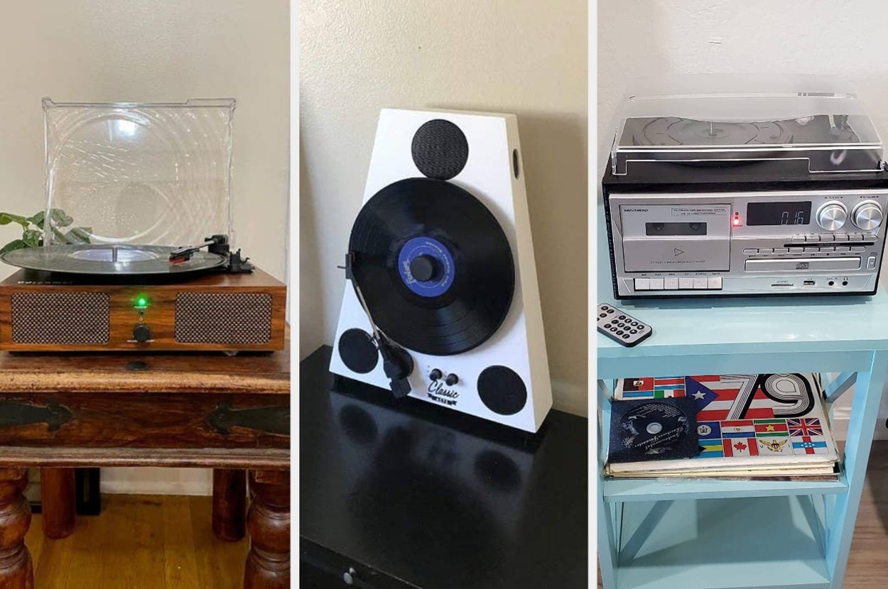 Reviewer image of wooden and clear turntable with black vinyl playing inside, white and black vertical turntable on top of black table, silver and black turntable radio on with clear lid on top of light blue side table