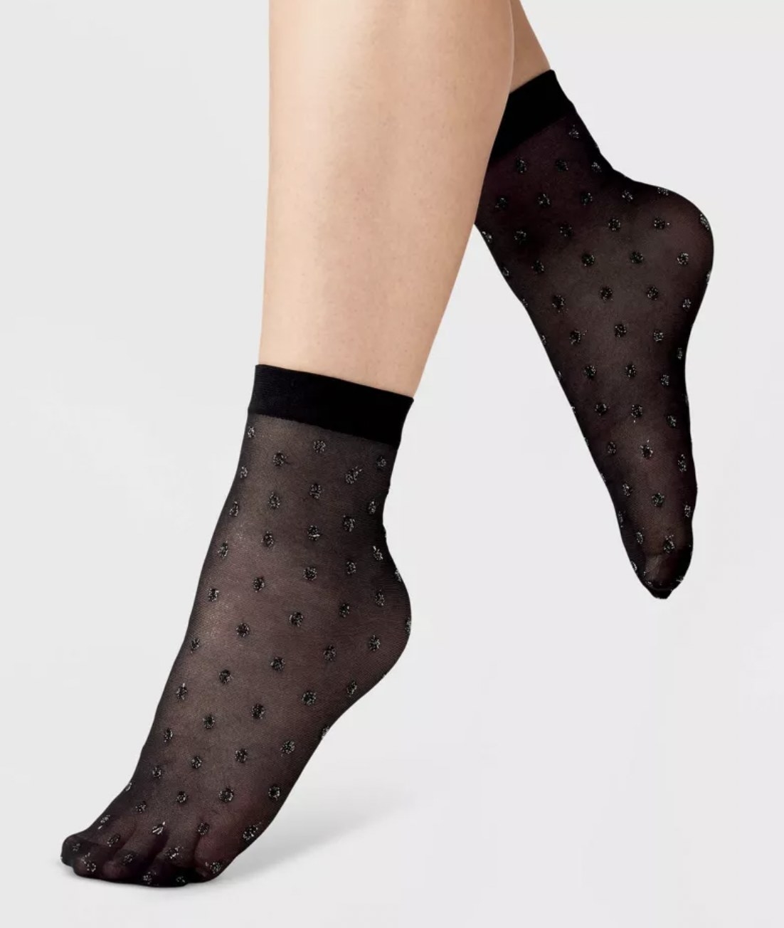a model wearing the black sheer sparkly socks