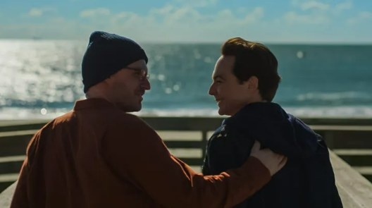 Kit (Ben Aldridge) and Michael (Jim Parons) in front of the ocean in a scene from &quot;Spoiler Alert&quot;