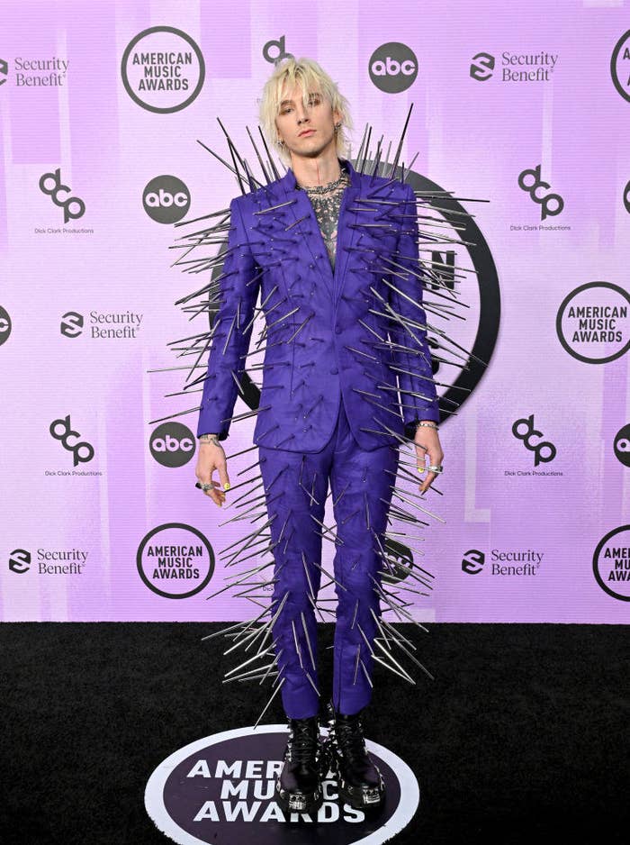 MGK wearing a fitted suit completely covered in long spikes