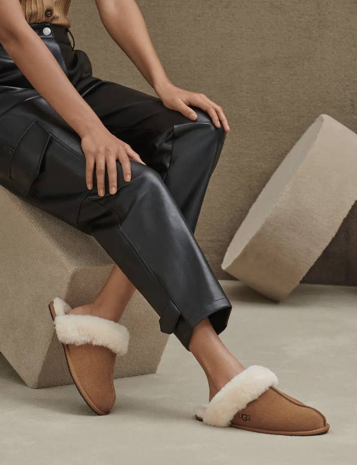 A person wearing the slippers and leather pants