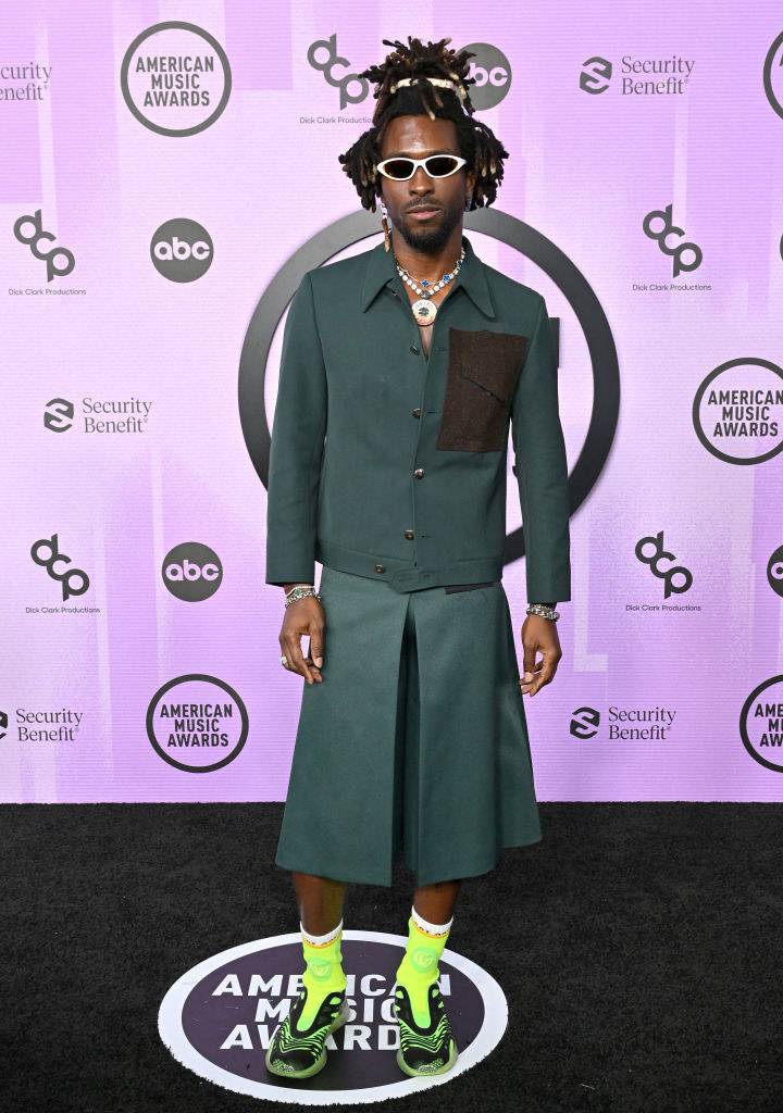 SAINt JHN in a green blazer and flare shorts