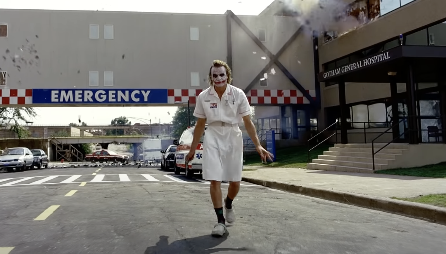 joker walking away from an exploding hospital building