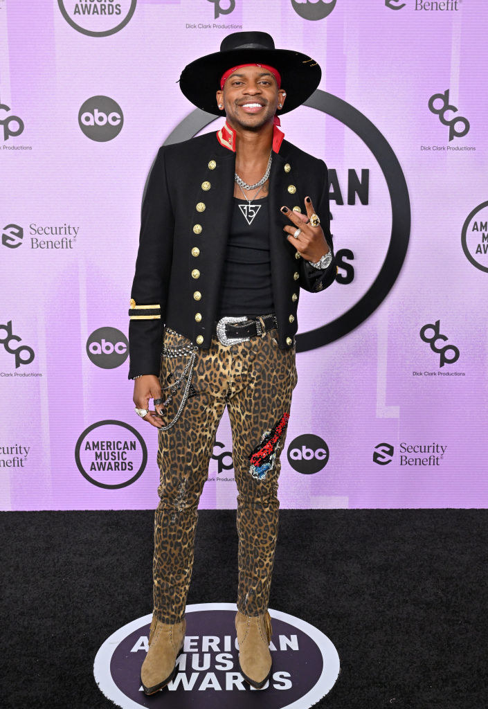 Jimmie Allen in a military-style jacker and cheetah trousers