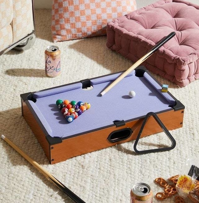 a mini pool table on a carpet
