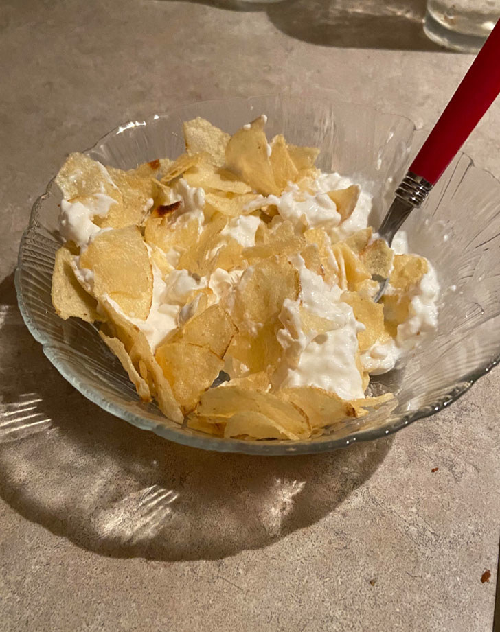 A bowl of Lays potato chips and cottage cheese.