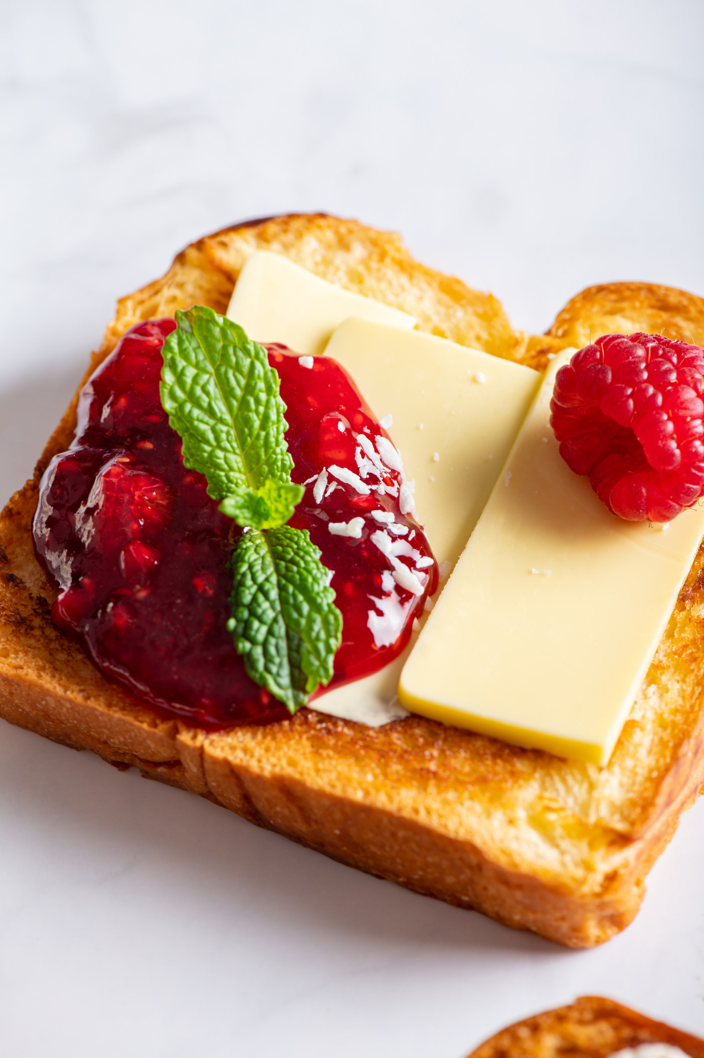 Toast with sliced cheese and jam.