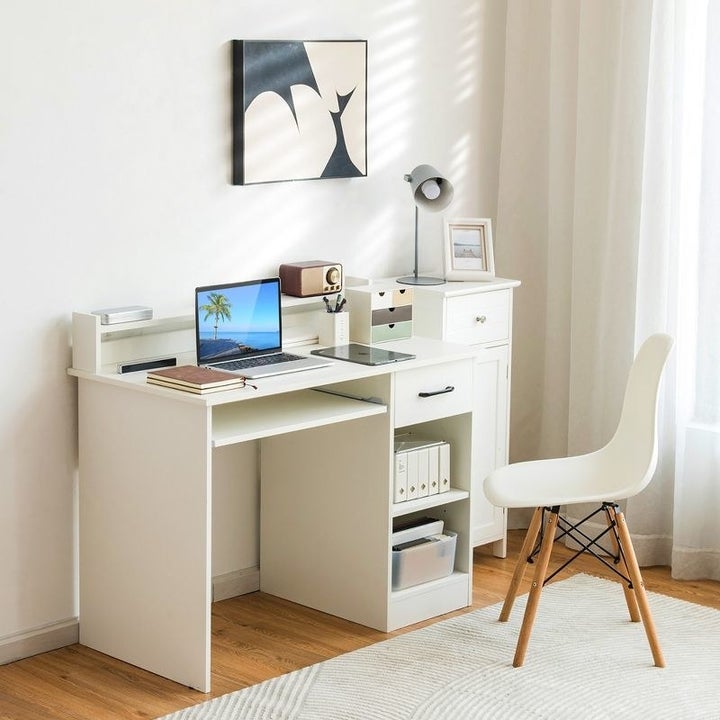 a white desk with built-in storage cubbies