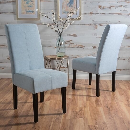 two light blue upholstered dining chairs