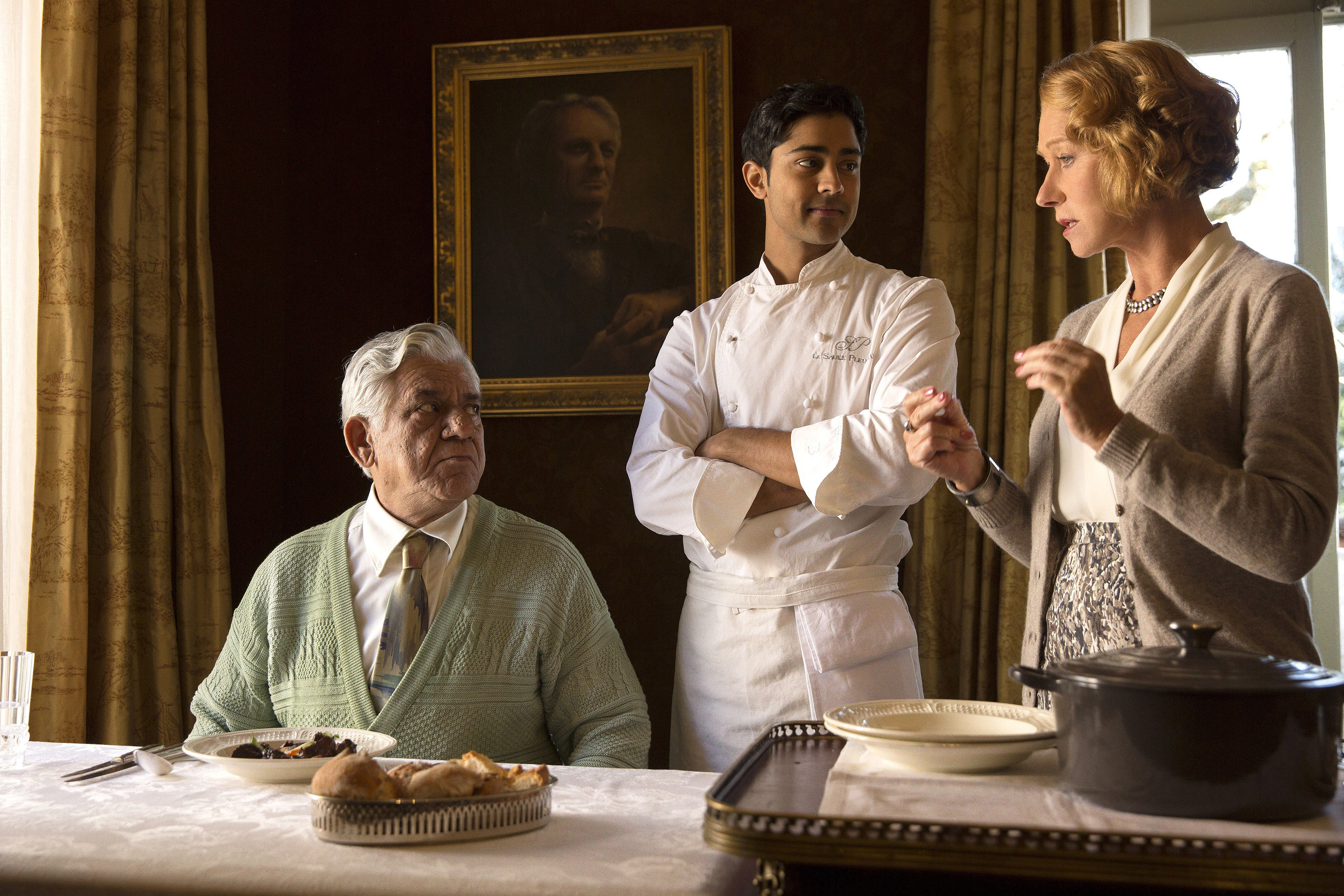 Helen Mirren and Manish Dayal talk to Om Puri at a table