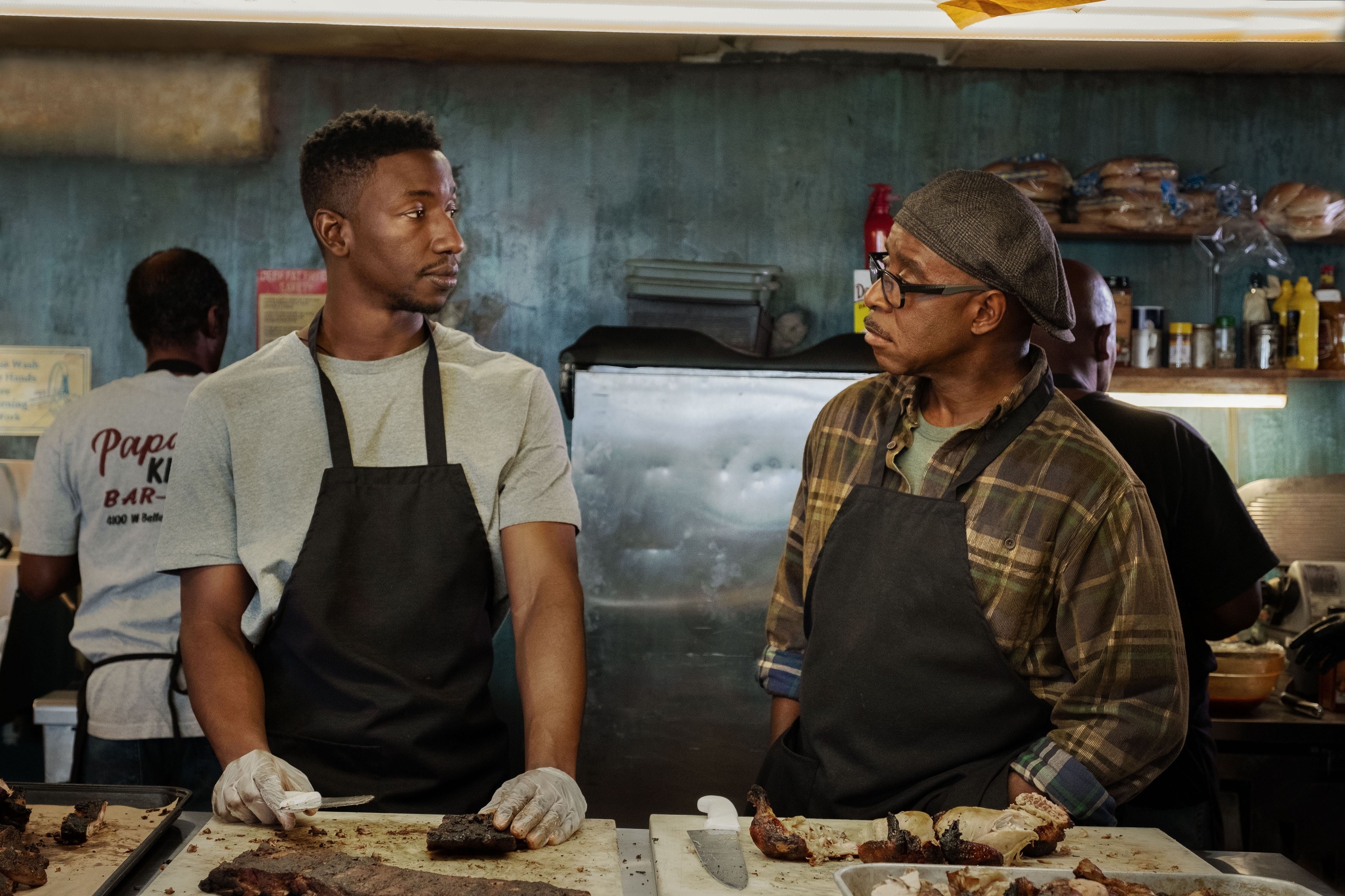 Mamoudou Athie and Courtney B. Vance stand in a kitchen together