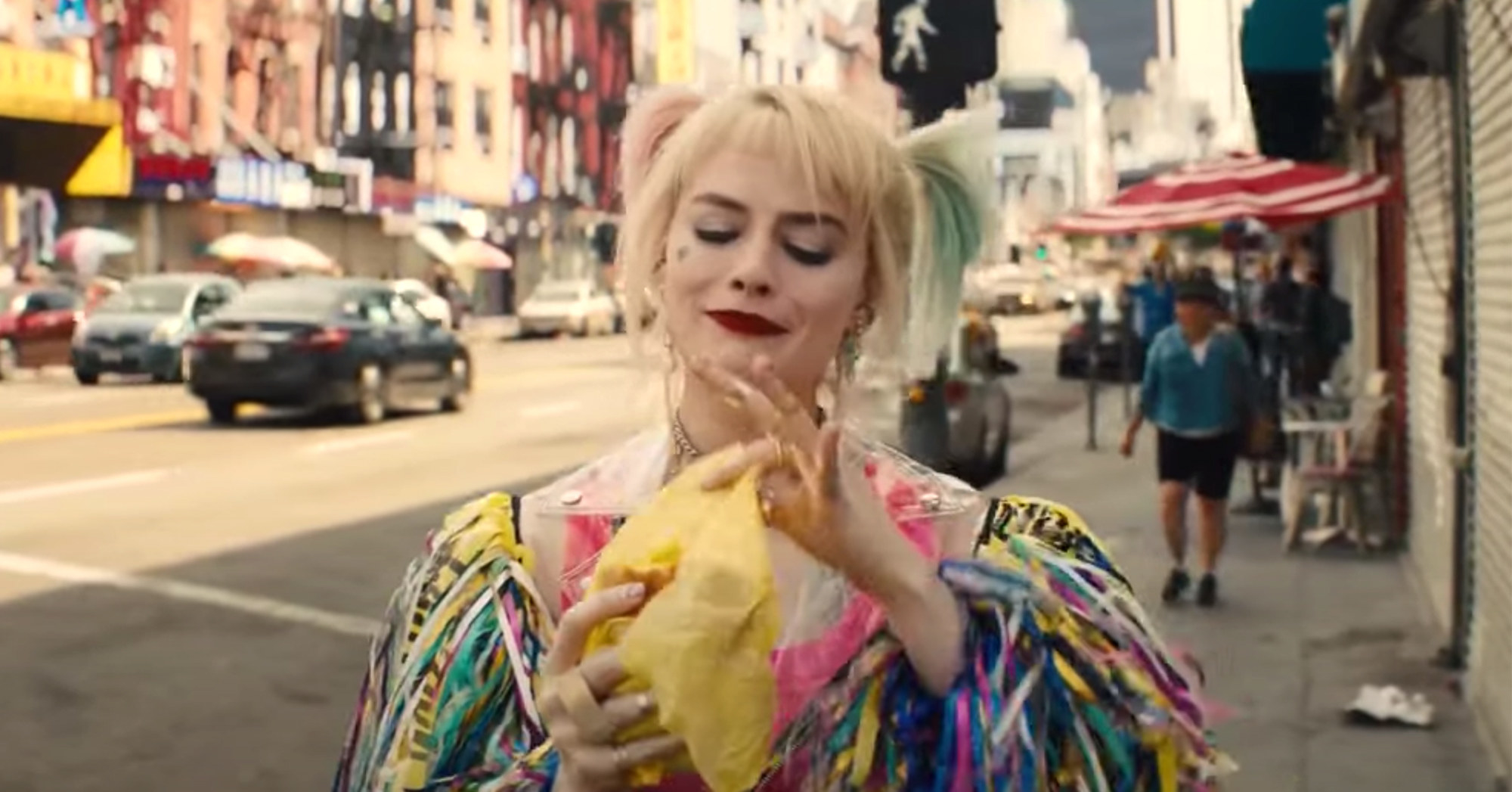 Margot Robbie eats a breakfast sandwich