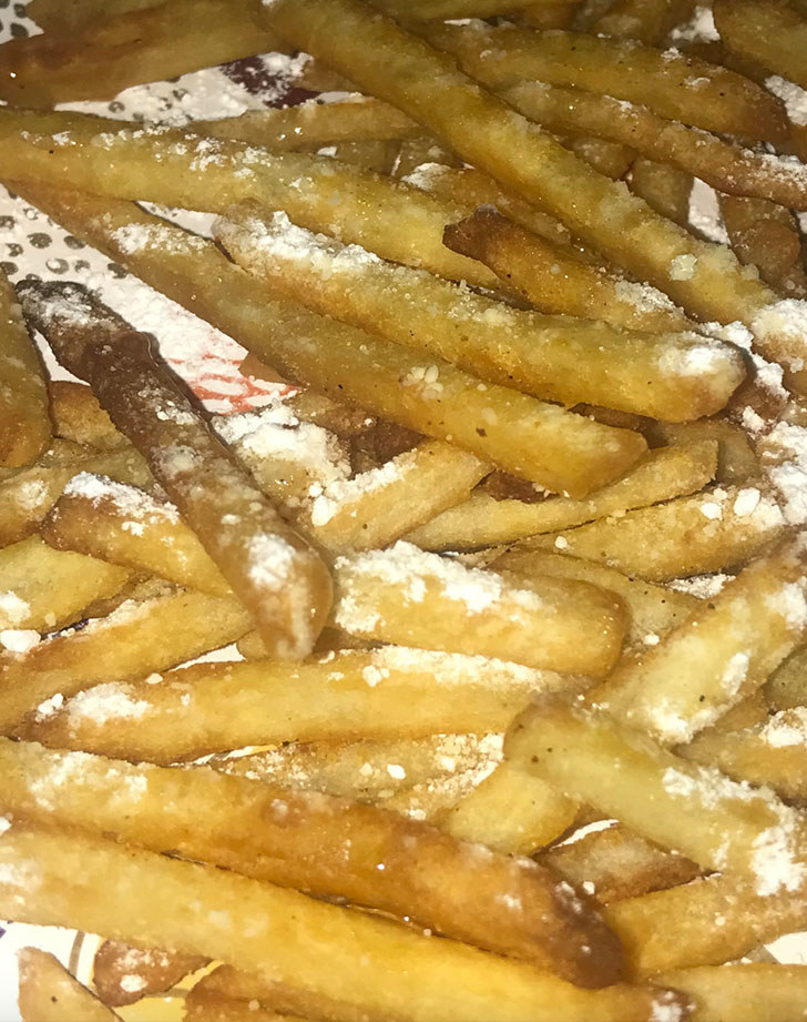 French fries topped with powdered sugar.