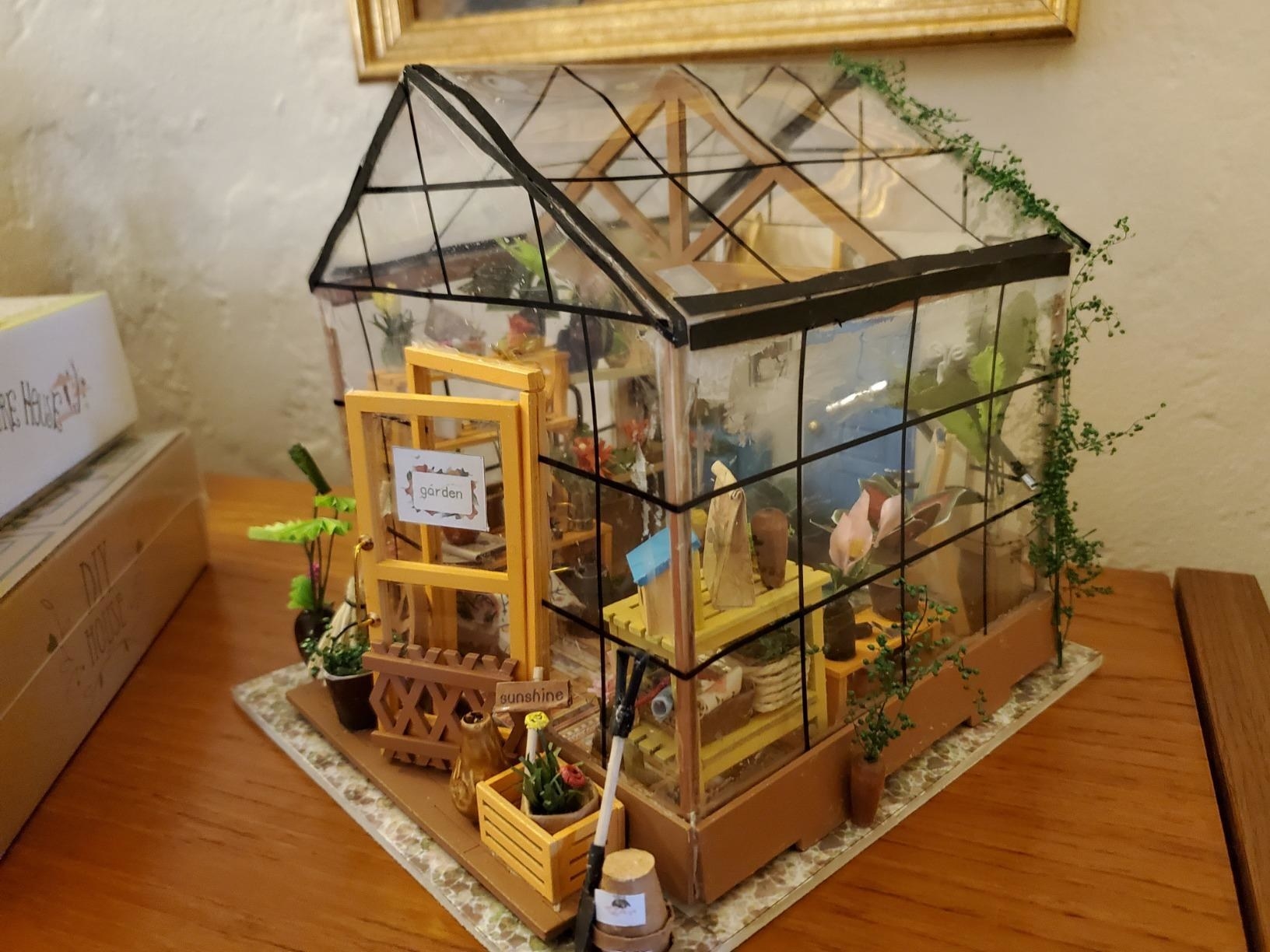 reviewer&#x27;s greenhouse built and on a table