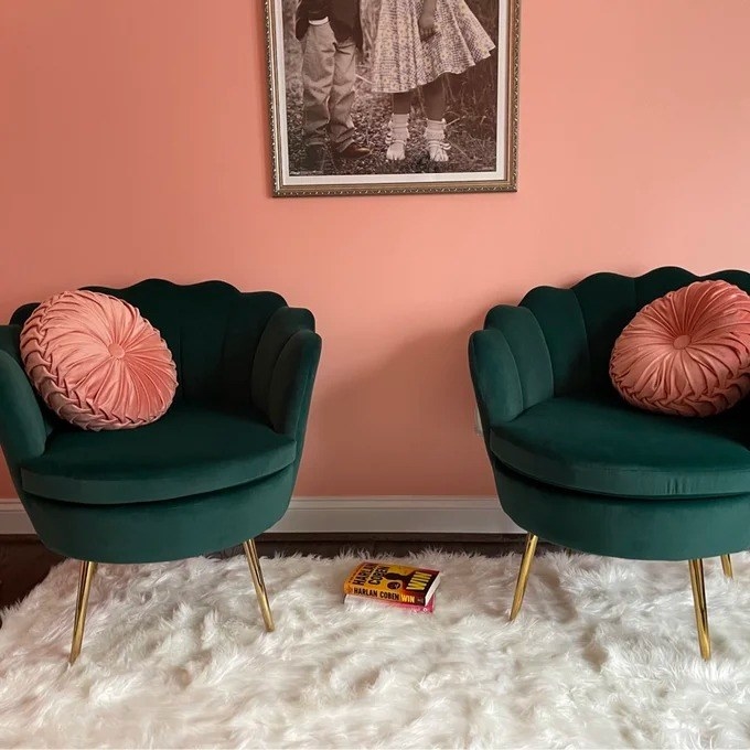 a reviewer photo of two of the green chairs with pink pillows