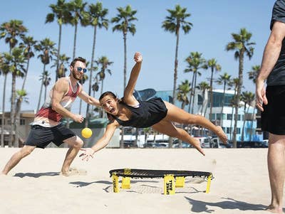 Friends on the beach playing Spikeball