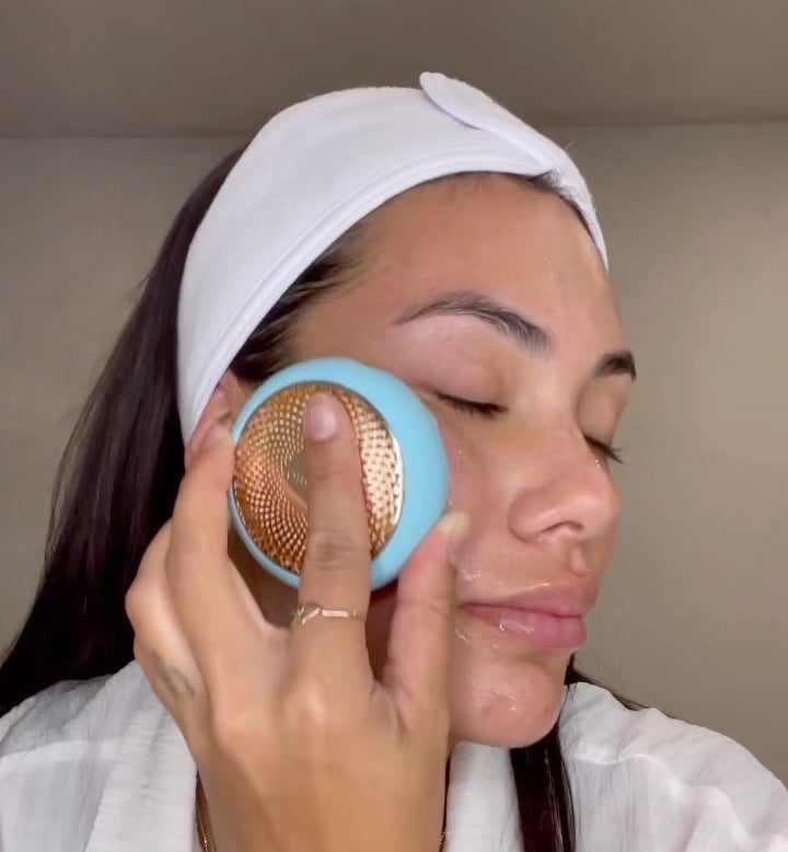 a person using the foreo device on their face
