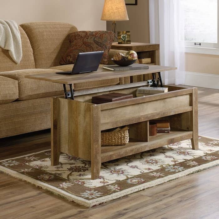 the wooden coffee table with the top extended
