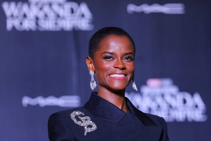 A closeup of Letitia smiling at the premiere of Black Panther: Wakanda Forever