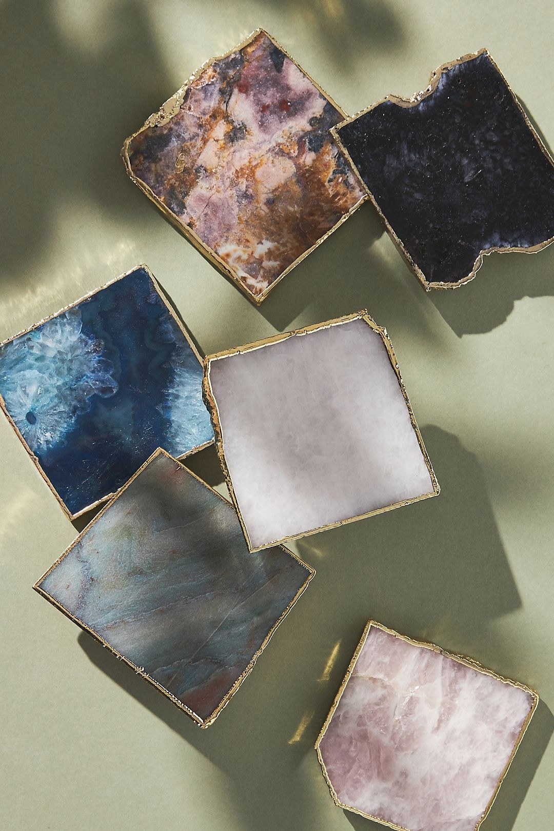 agate coasters in various colors all with gold edges