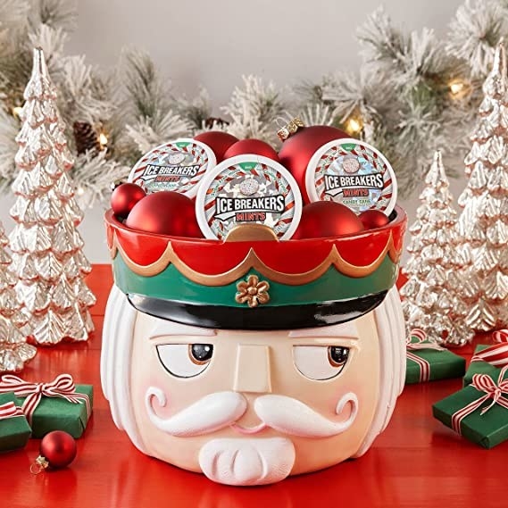 a nutcracker head filled with candy cane ice breaker mint packages