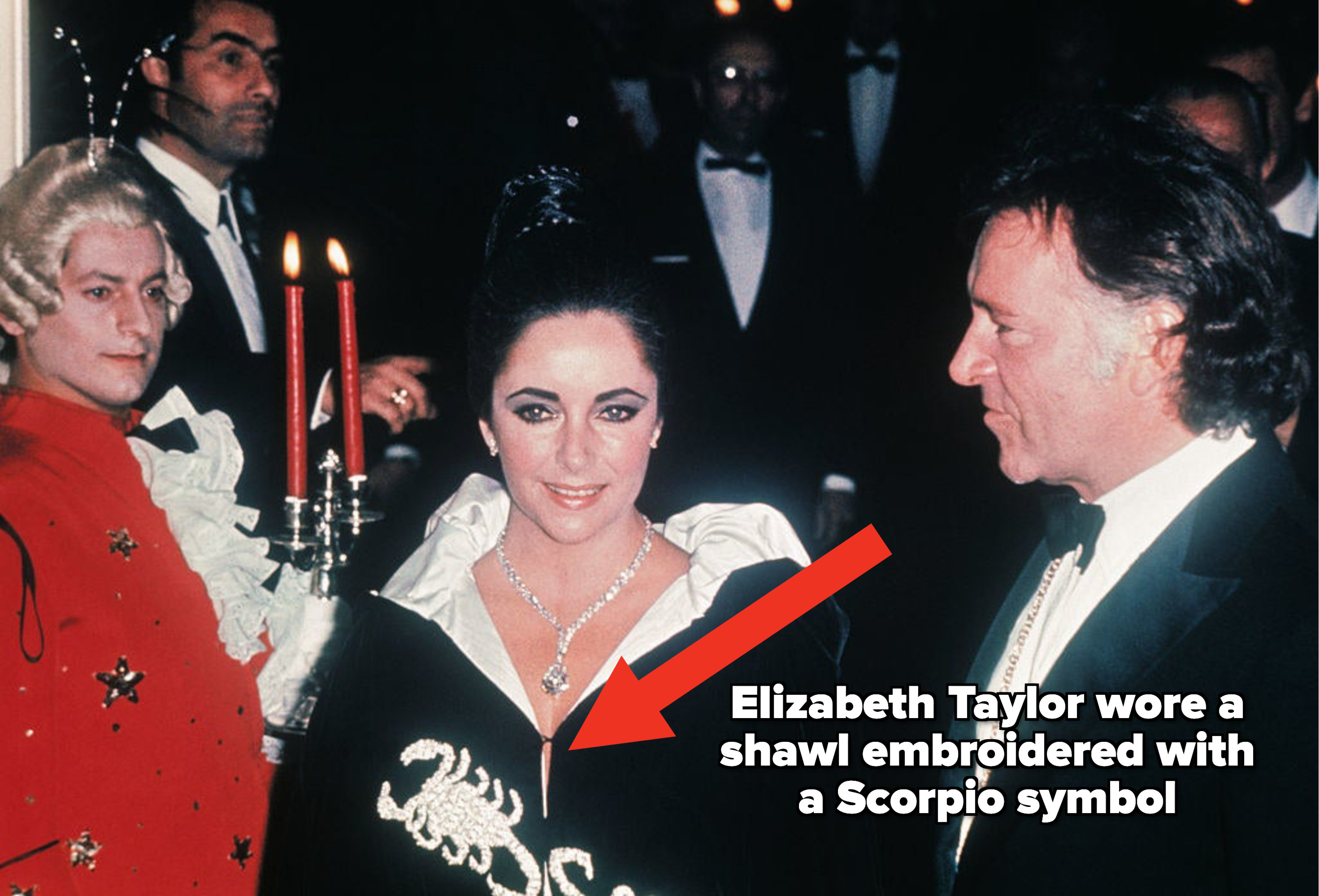 arrow pointing to Elizabeth taylor wearing a shawl that was embroidered with a scorpio symbol